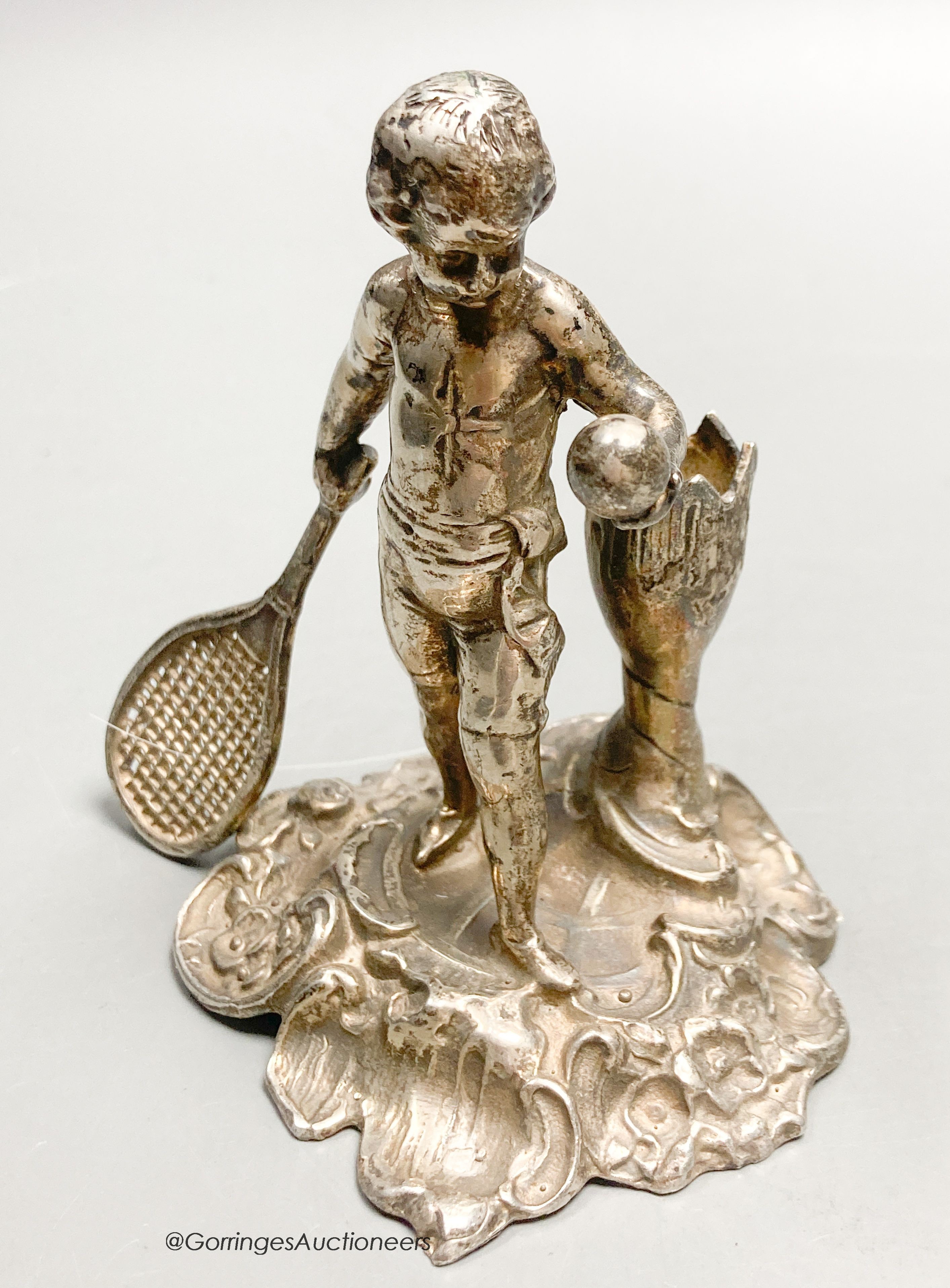 A French? white metal figural posy holder? modelled as a youth playing tennis, 9.1cm